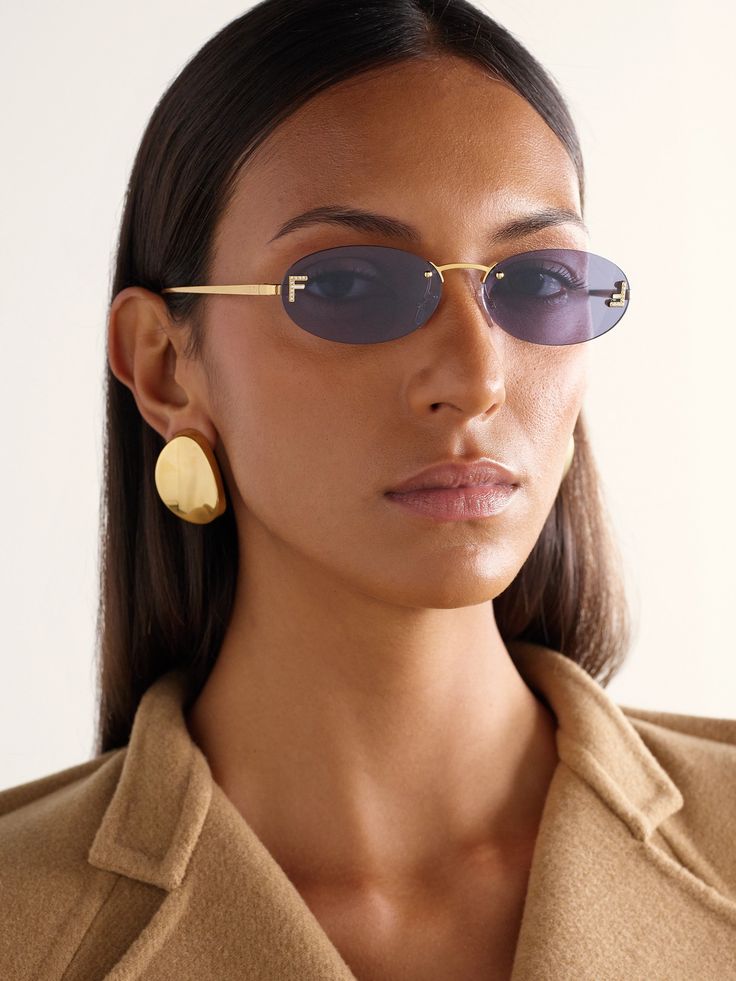 woman wearing gold colored Fendi sunglasses.