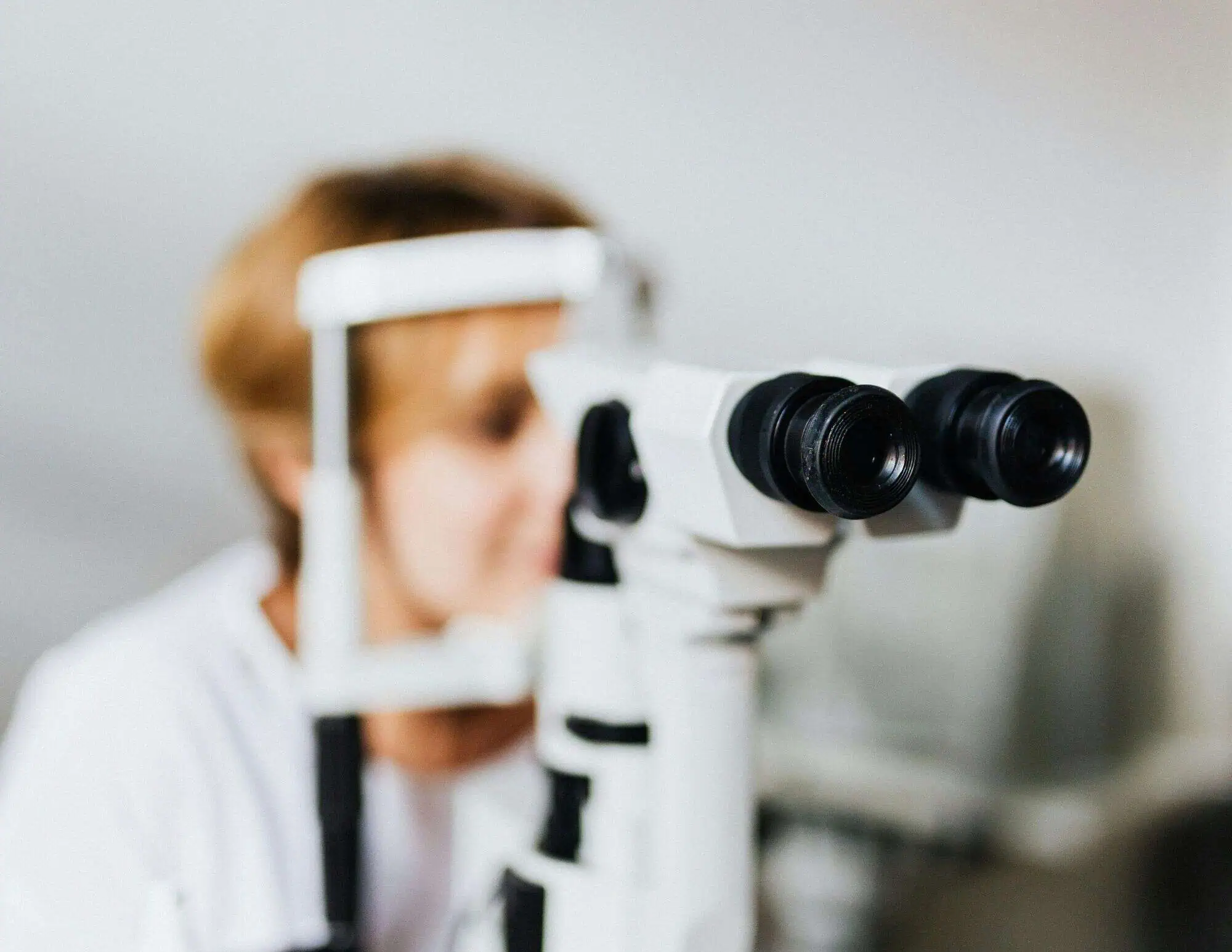 Woman getting a quality eye exam at Mango Optic in Boca Raton.