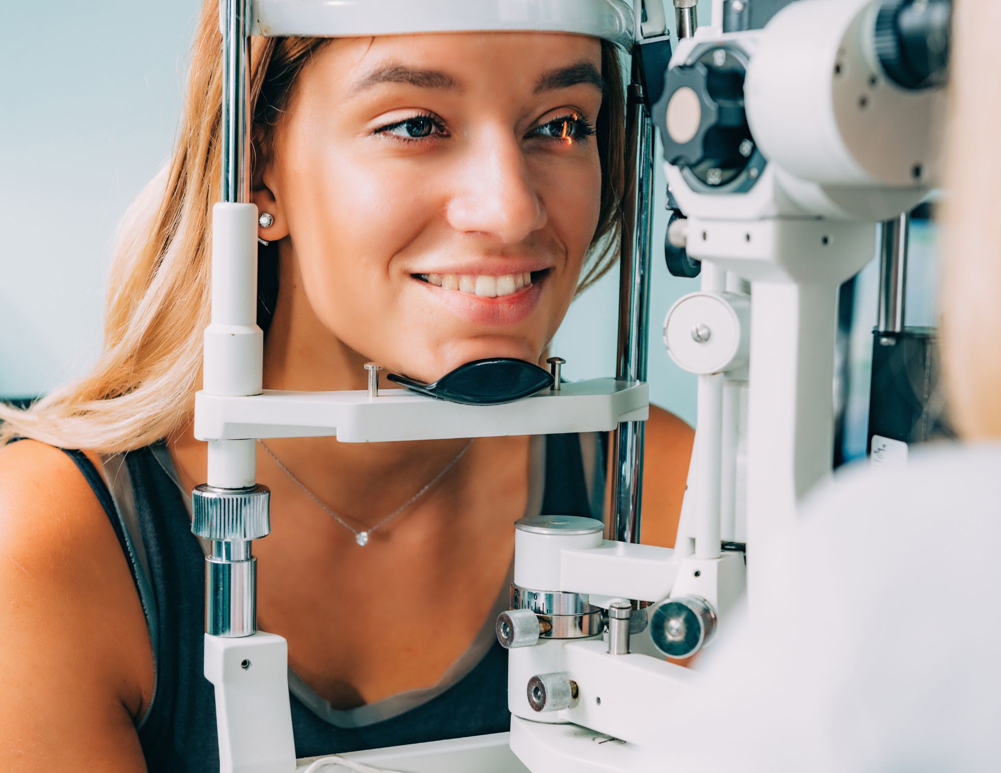Woman getting comprehensive eye exam at Mango Optic in Boca Raton.