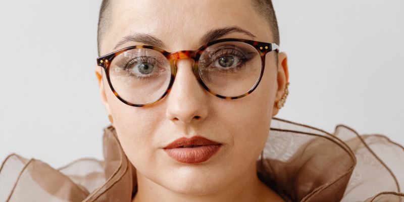 Woman wearing designer prescription glasses at Mango Optic in Boca Raton.