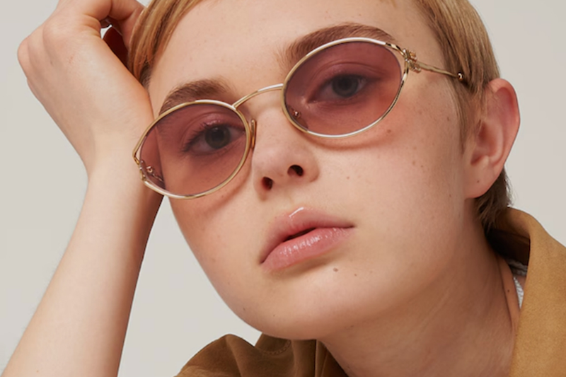 Woman wearing gold sunglasses.