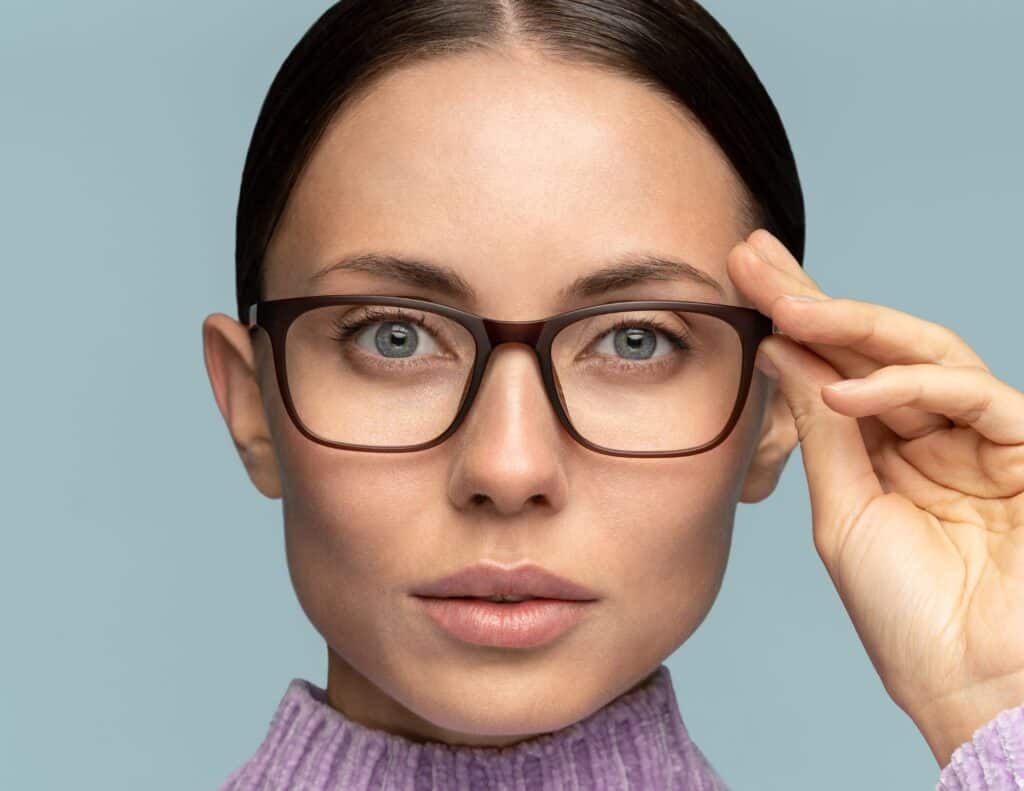 Woman wearing glasses with blue light block technology from Mango Optic.